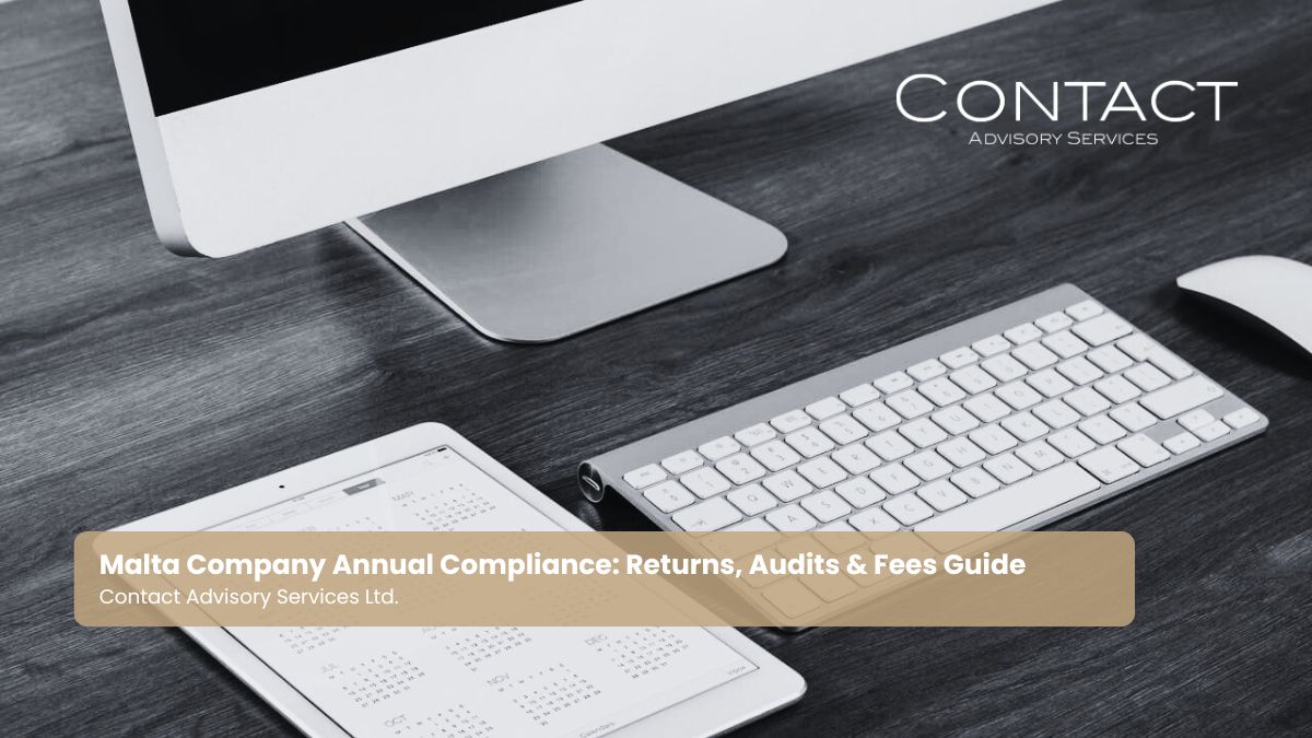 A computer and calendar page showing a full year, for key compliance dates